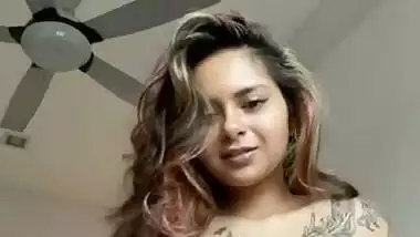 Beautiful tattoed girl showing her boobies