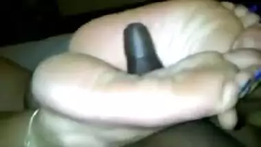 Indian woman with long toenails giving footjob